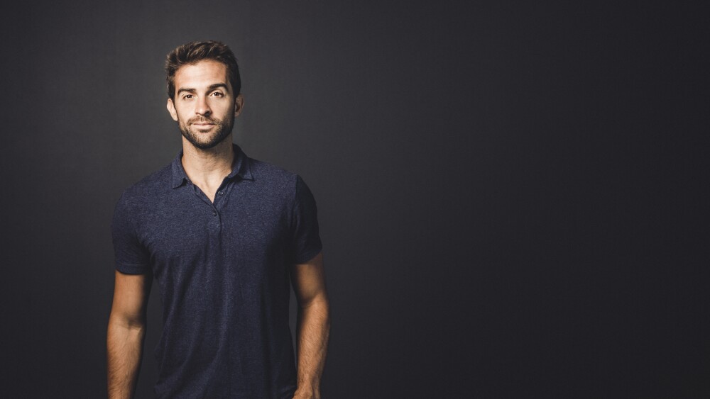 Fashionable man standing with hand in pocket