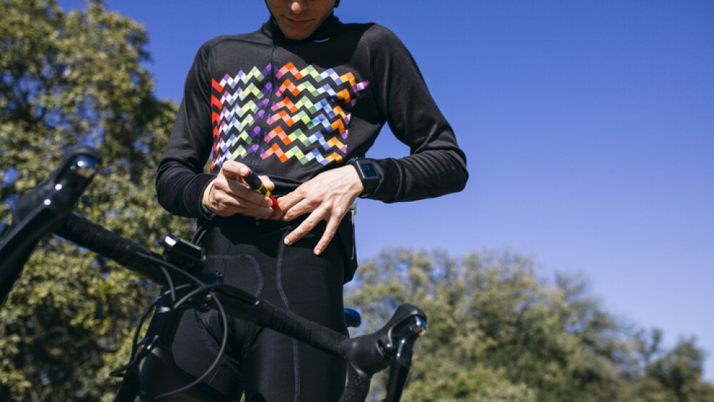 Diabetic cyclist injecting insulin before starting his ride