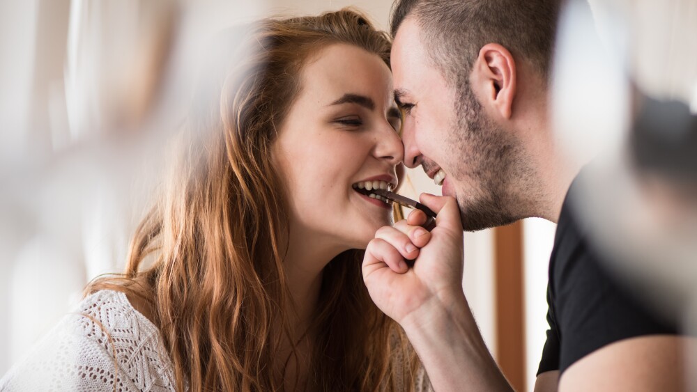 Closeness of a couple while sharing chocolate