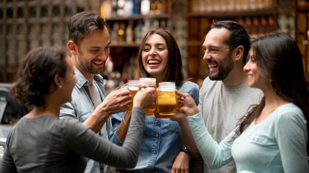 Happy group of friends making a toast at a restaurant