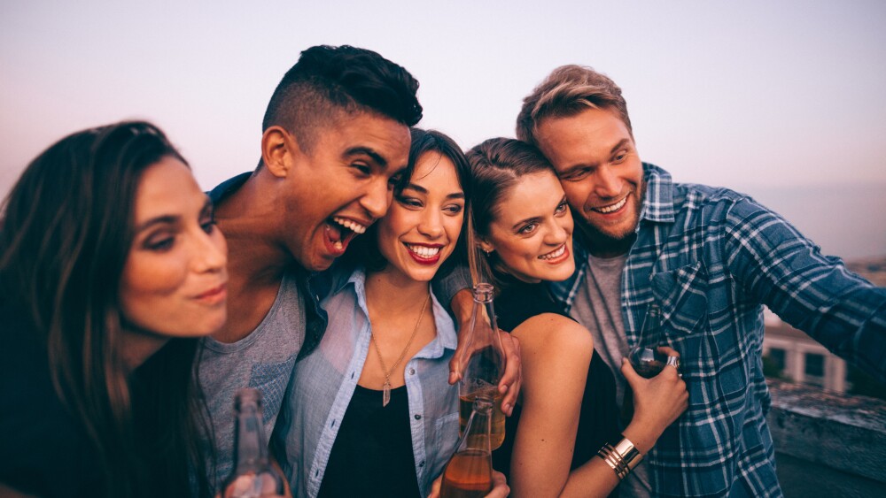 Young adults taking a funny selfie outdoors